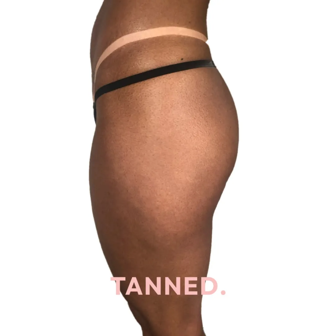 Crisp tan line — deep even bronze and a defined edge, colour depth from a Tanned session